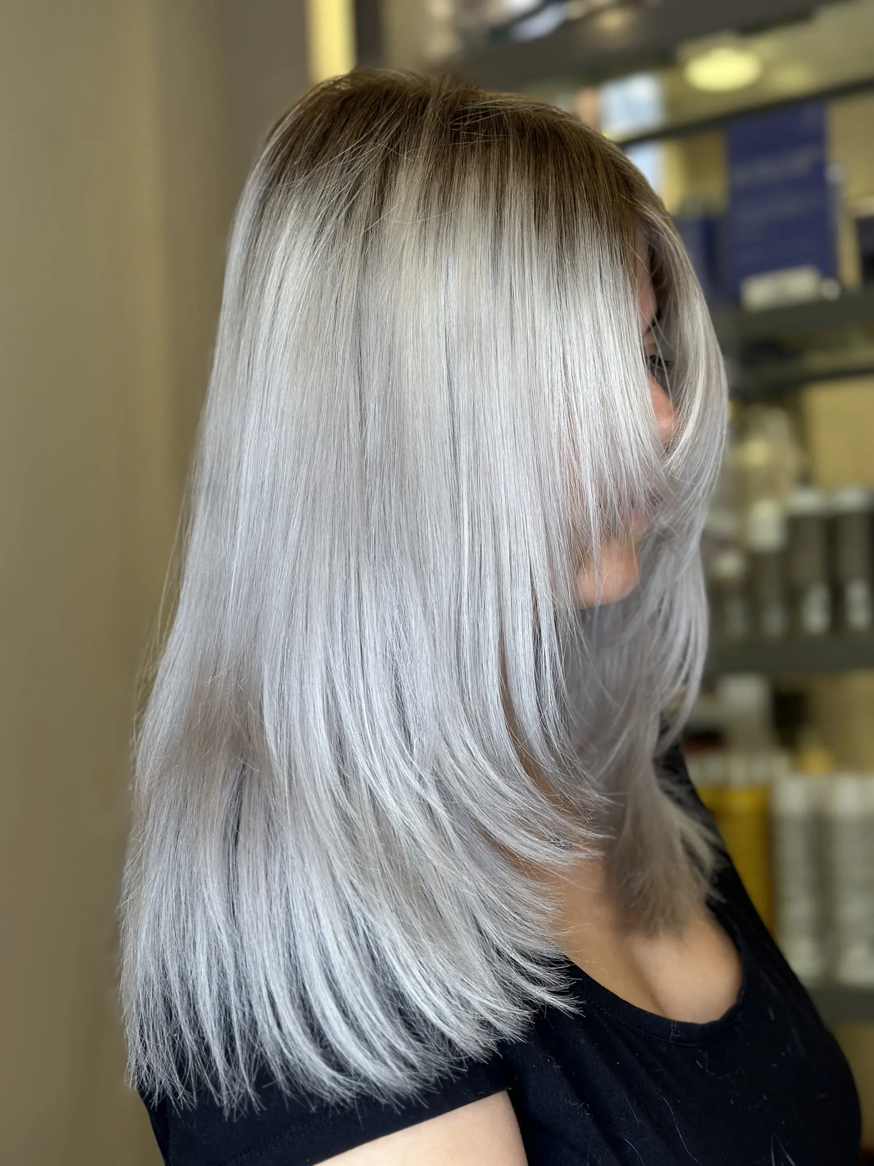 Icy platinum blonde with soft layers by Ronak Hairstylist in Toronto