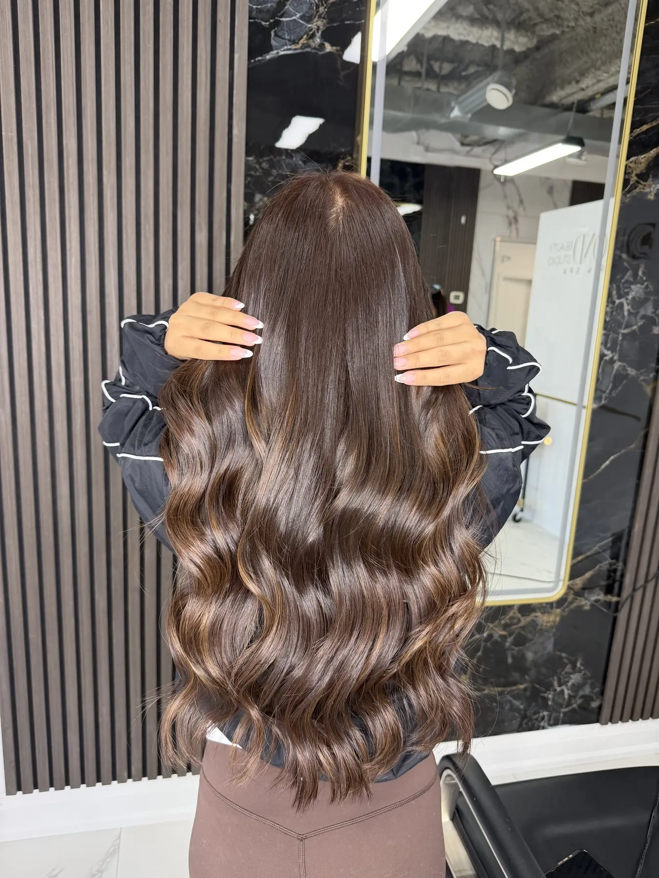 Long glossy brunette waves by Ronak Hairstylist in Toronto